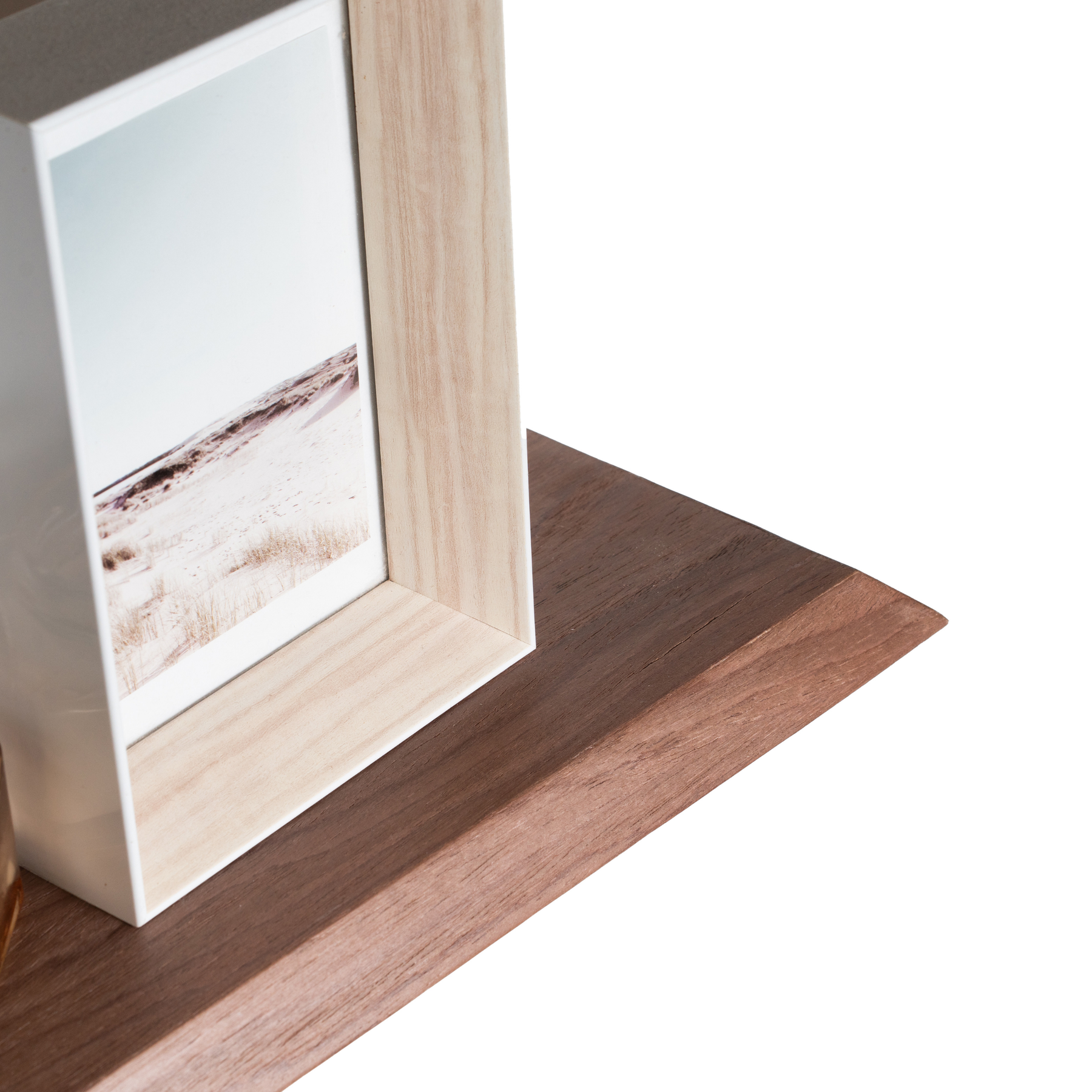 Close-up of the edge of the wood curved floating shelf with solid middle wave section and inclined edges